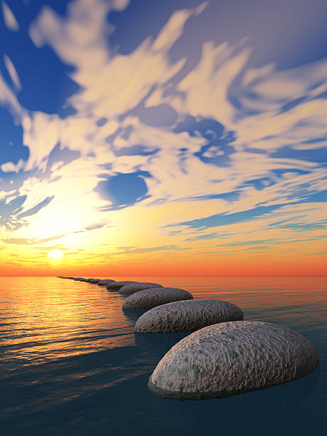 Galets en pas japonais sur la mer menant vers un coucher de soleil